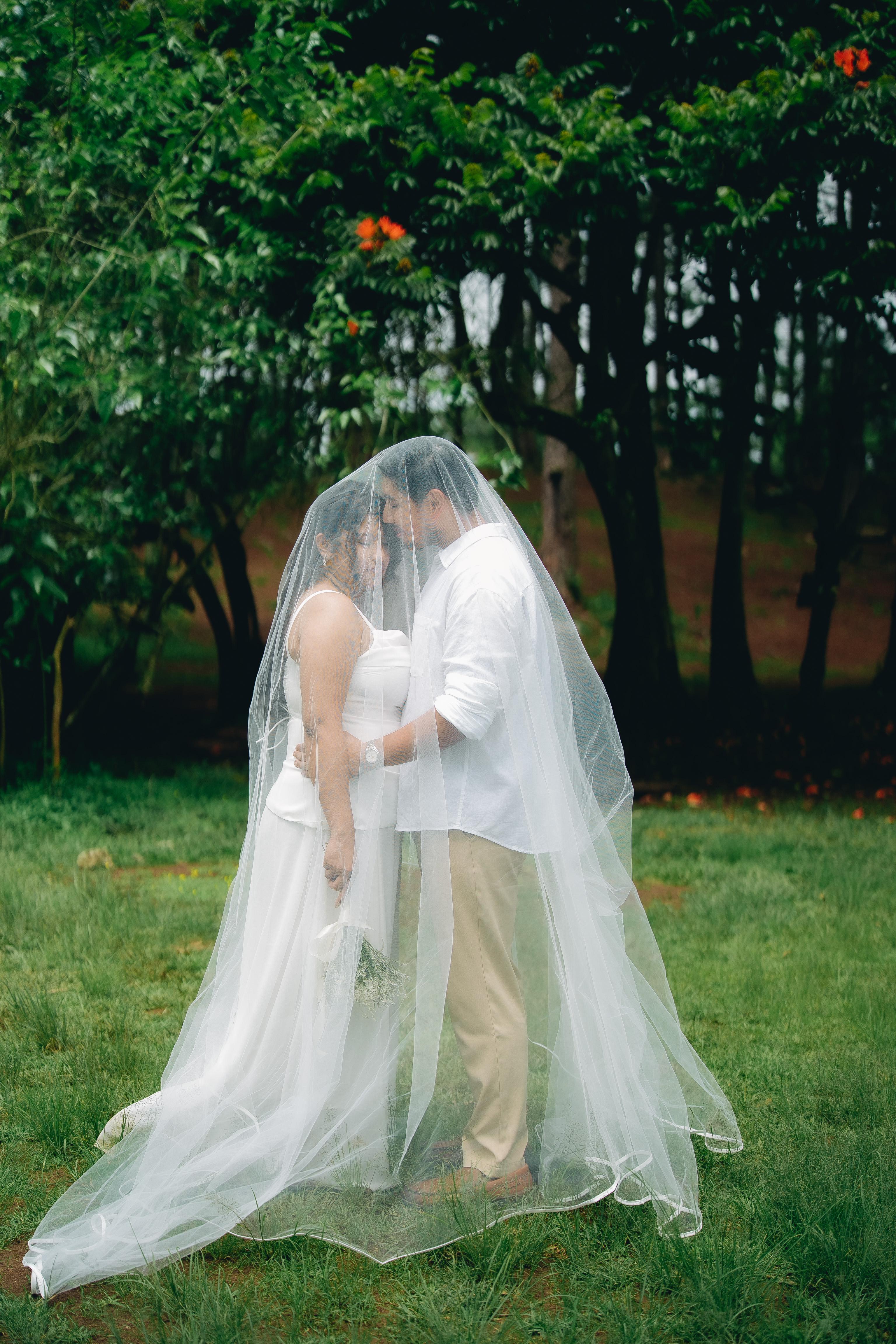 Verna Liza Bautista and Peter Gerardo Jose Ongoco beneath the bridal veil